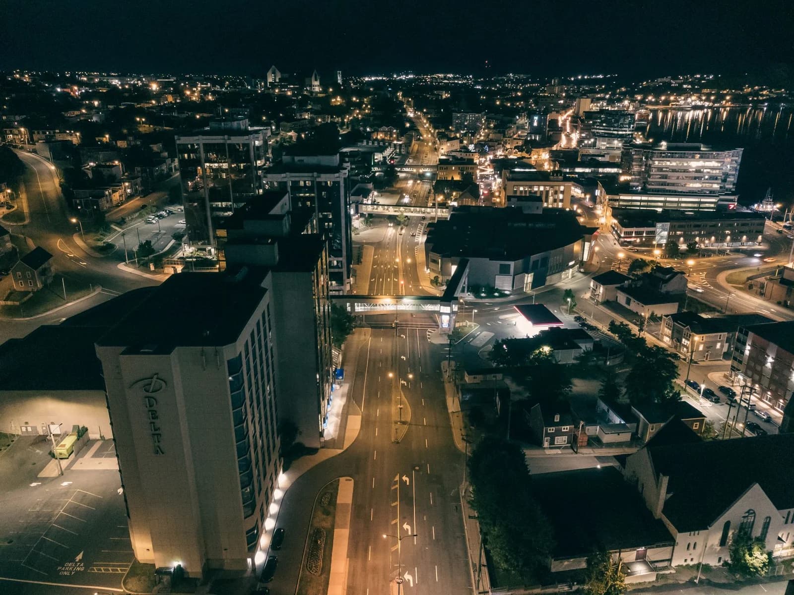 Stunning nighttime aerial view of illuminated St. John's cityscape in Newfoundland and Labrador, Canada.