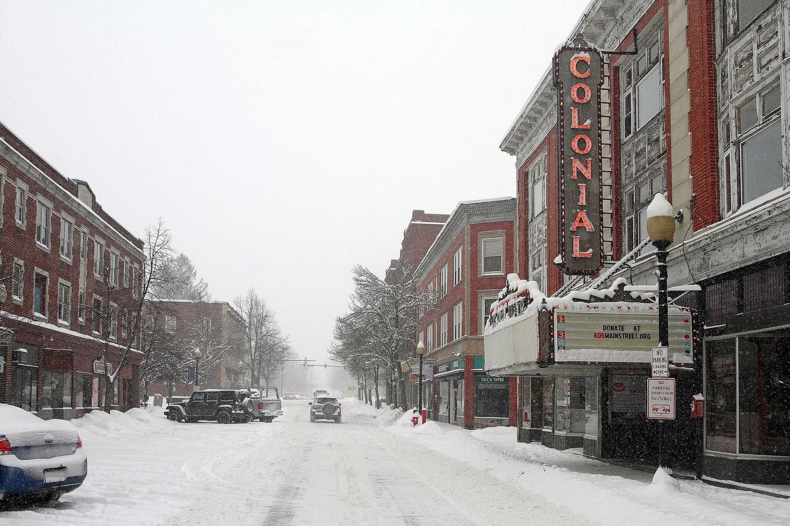 Main Street in Laconia, New Hampshire during a snowstorm, with the Colonial Theatre marquee