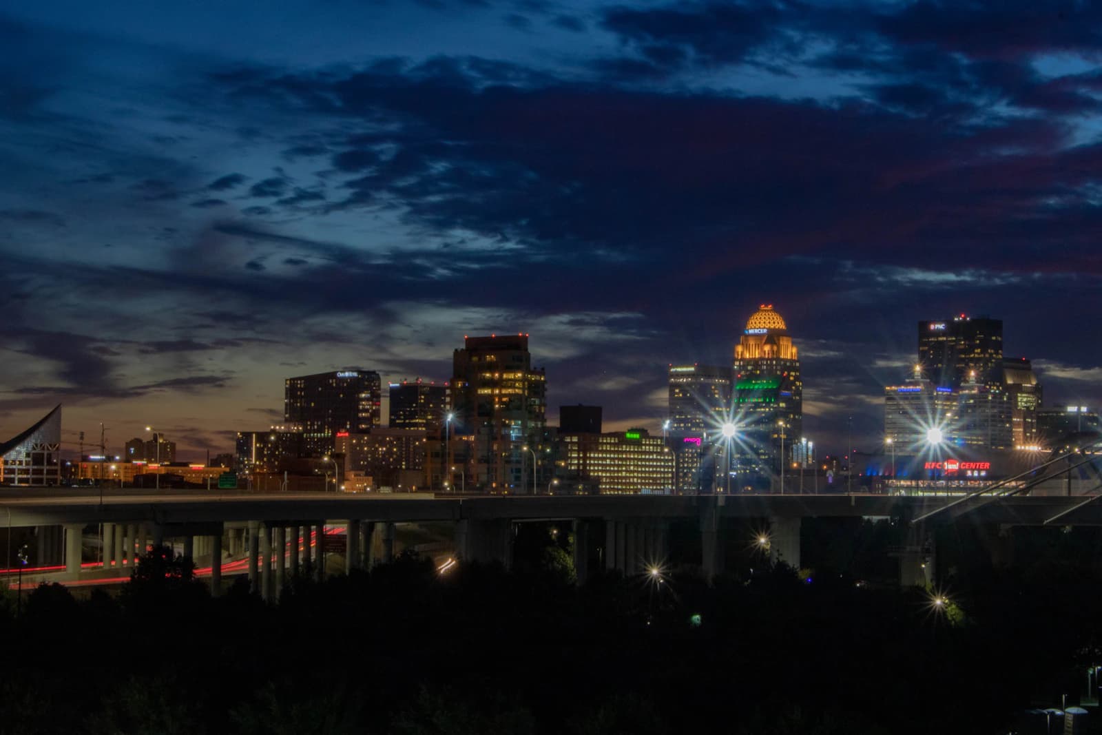 Louisville Kentucky skyline at dusk viewed from the Big Four Walking Bridge over the Ohio River