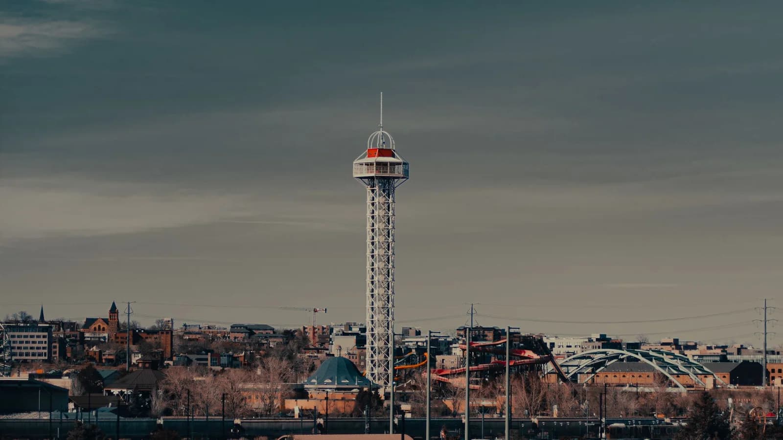 Dramatic view of a distinctive urban tower against a moody sky.
