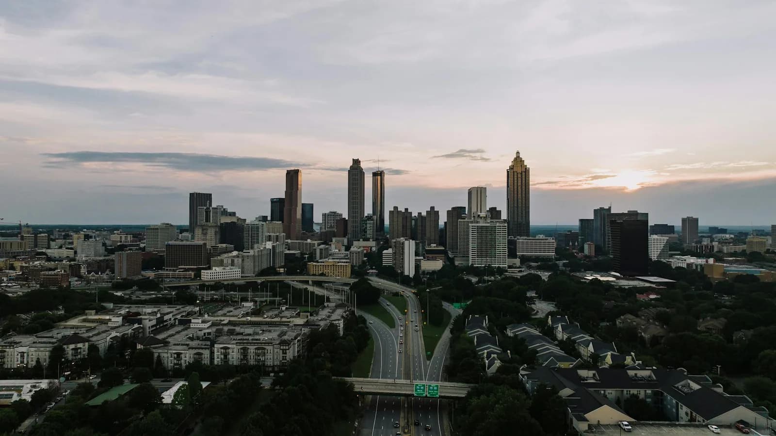Captivating aerial view of the Atlanta skyline at dusk, showcasing the city's iconic skyscrapers and bustling highways.
