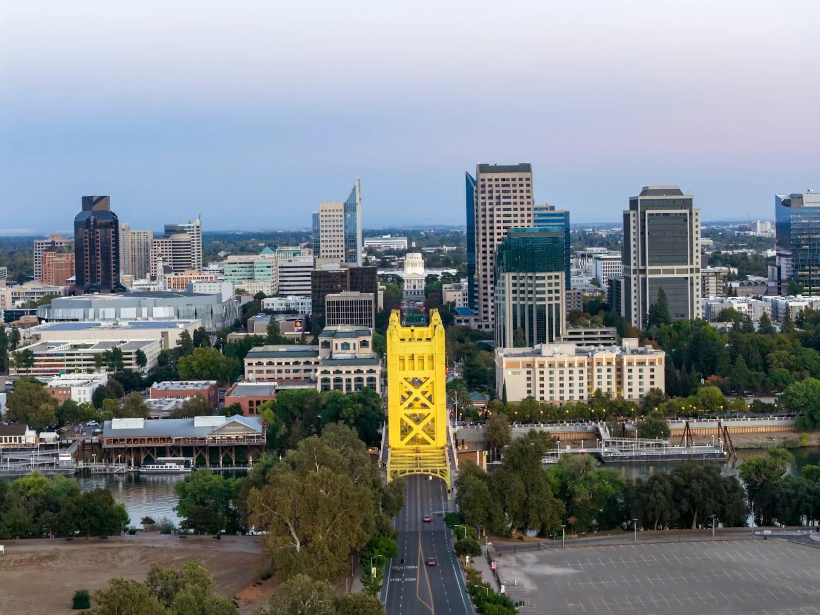 Tower Bridge and the Sacramento skyline at dusk with the California State Capitol dome behind it