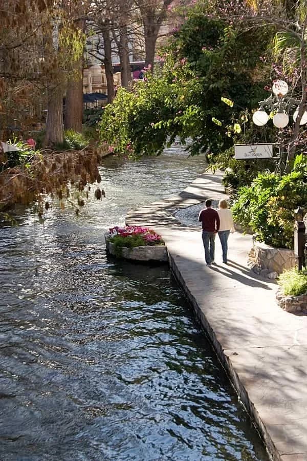 San Antonio River Walk lined with restaurants and bridges