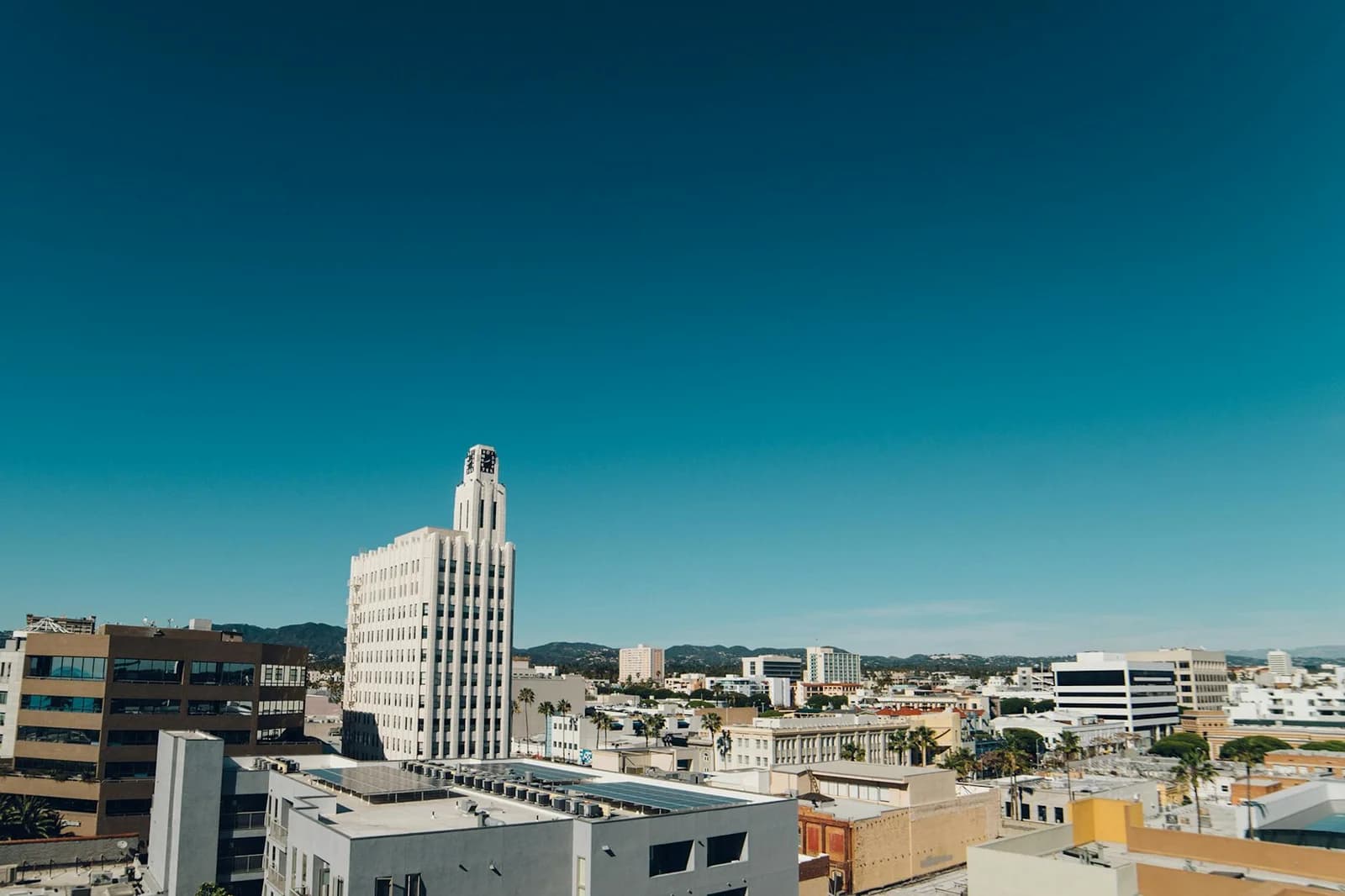 Aerial view of Santa Monica city skyline on a bright day with clear blue skies.