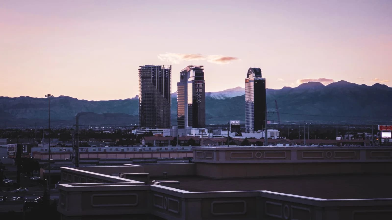 Captivating view of Las Vegas skyline against a mountain backdrop during dusk.