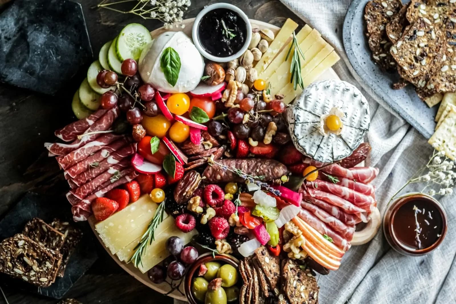 Charcuterie - A variety of cheeses, crackers, and cured meats arranged on a platter