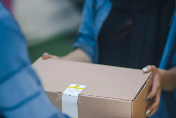 A package being handed from one person to another