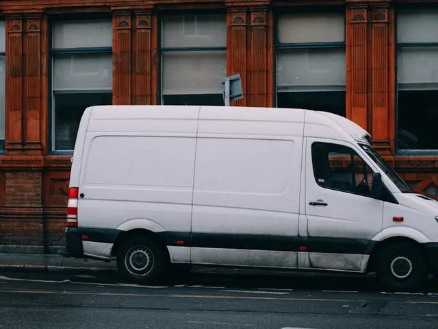 A white cargo van parked on a street